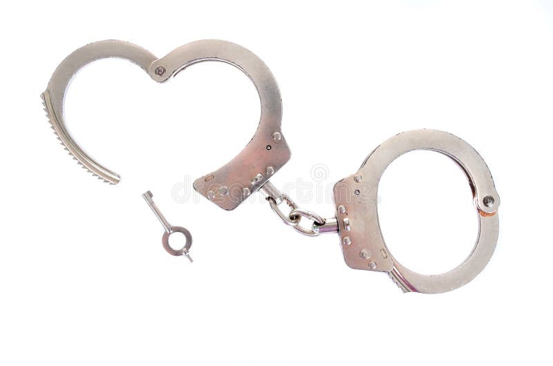 Photo of a pair of handcuffs isolated on a white background. Photo of a pair of handcuffs isolated on a white background