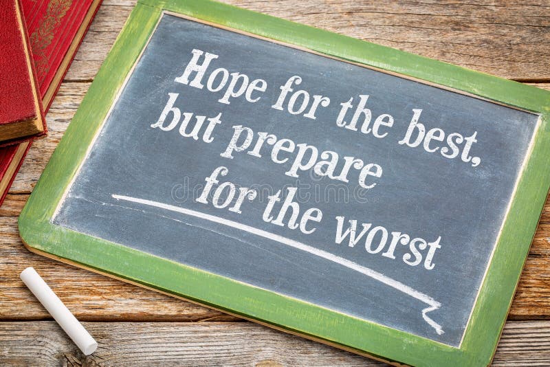 Hope for the best but prepare for the worst - advice on a slate blackboard with a white chalk and a stack of books against rustic wooden table. Hope for the best but prepare for the worst - advice on a slate blackboard with a white chalk and a stack of books against rustic wooden table