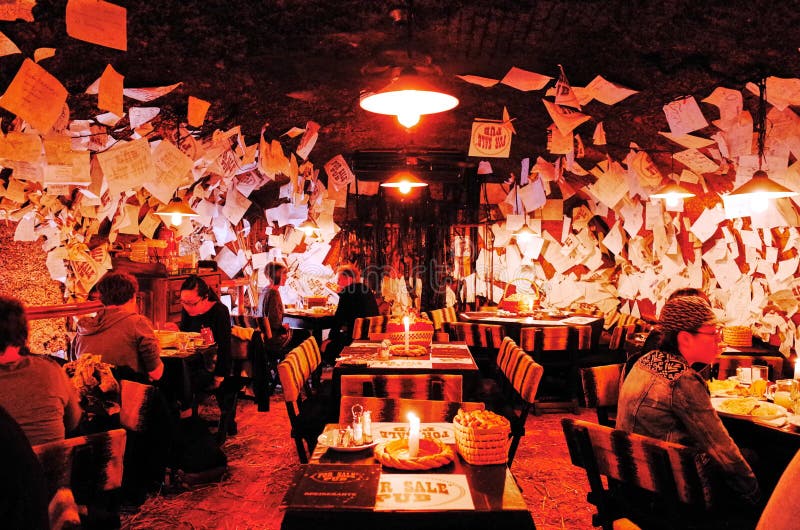 Budapest, HUNGARY - OCTOBER 23, 2014: For Sale Pub. This Budapest bar allows drinkers to leave their mark on the walls, floor, and even ceiling. Budapest, HUNGARY - OCTOBER 23, 2014: For Sale Pub. This Budapest bar allows drinkers to leave their mark on the walls, floor, and even ceiling.