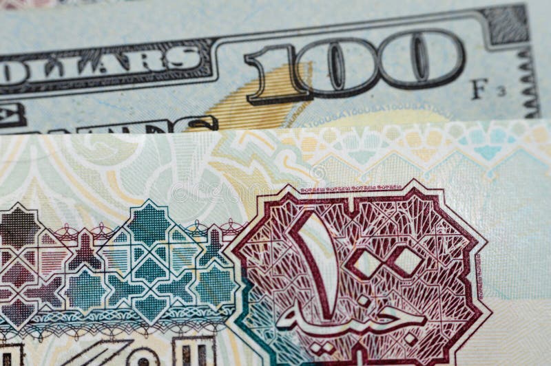 Closeup Egyptian money banknotes of 100 EGP LE one hundred pounds bill and USD American cash of 100 dollars, money exchange rates of Egypt and United states of America, inflation and economy concept. Closeup Egyptian money banknotes of 100 EGP LE one hundred pounds bill and USD American cash of 100 dollars, money exchange rates of Egypt and United states of America, inflation and economy concept