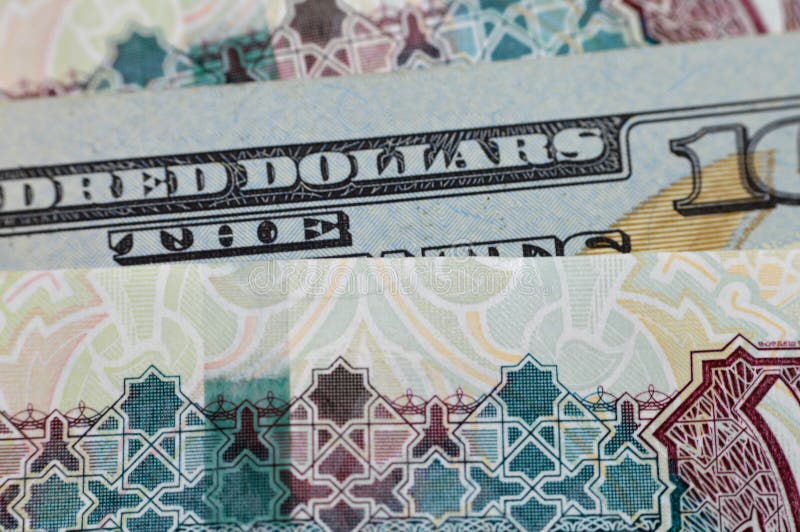 Closeup Egyptian money banknotes of 100 EGP LE one hundred pounds bill and USD American cash of 100 dollars, money exchange rates of Egypt and United states of America, inflation and economy concept. Closeup Egyptian money banknotes of 100 EGP LE one hundred pounds bill and USD American cash of 100 dollars, money exchange rates of Egypt and United states of America, inflation and economy concept