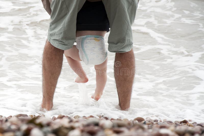 Feet of father and baby child wadding in a sea water, parenting concept. Feet of father and baby child wadding in a sea water, parenting concept.
