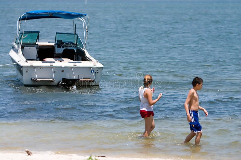 Brother and stepsister walking away from boat. Brother and stepsister walking away from boat