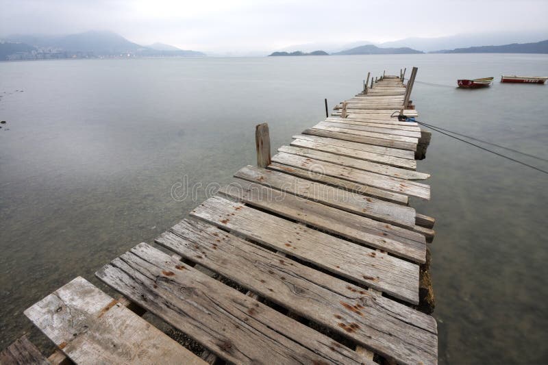 Looking over a desolate peer and a boat. Looking over a desolate peer and a boat