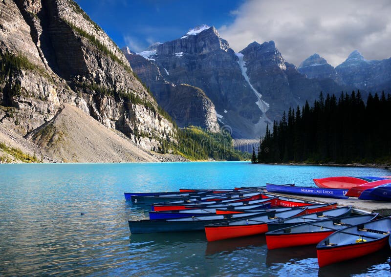 Colorful boats on Moraine Lake in Canadian Rockies. Banff National Park. Alberta Canada. Colorful boats on Moraine Lake in Canadian Rockies. Banff National Park. Alberta Canada