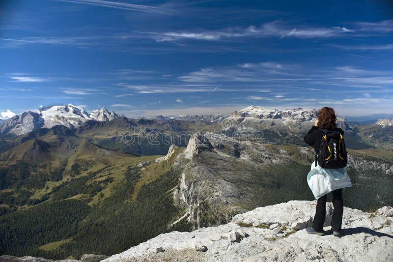 The woman on the steep peer at mountains. The woman on the steep peer at mountains