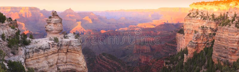 Panorama of the Grand Canyon (South Rim) with Sunset Colors Reflecting in the Rocks. Panorama of the Grand Canyon (South Rim) with Sunset Colors Reflecting in the Rocks.
