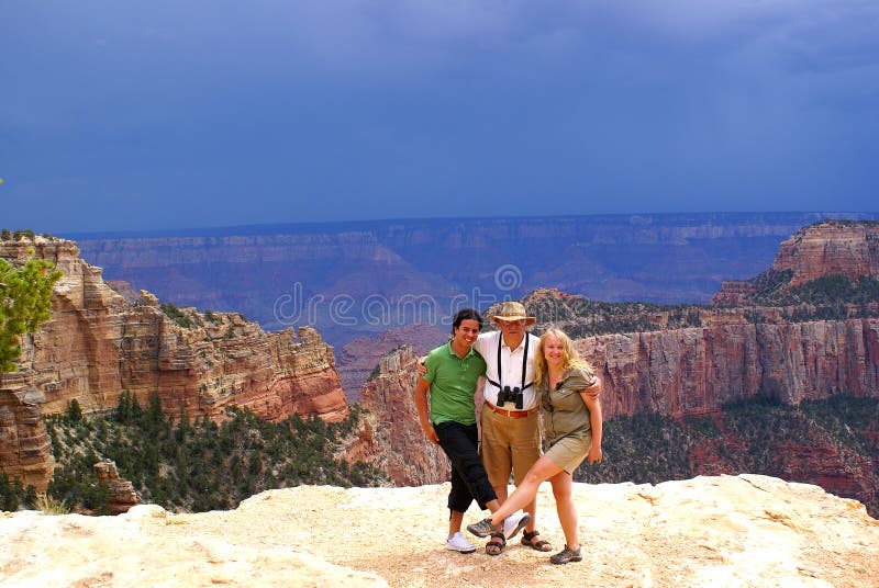 Tourists in Grand Canyon North Rim - view before the storm. Tourists in Grand Canyon North Rim - view before the storm