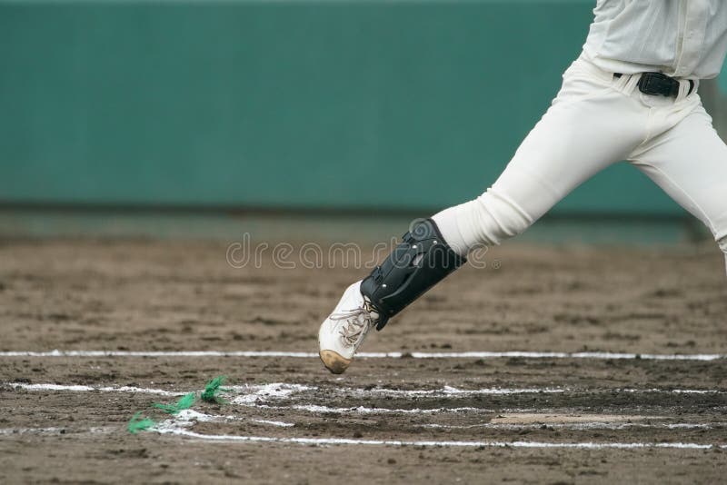 A left-hander timing a pitch thrown by a pitcher during a baseball game. A left-hander timing a pitch thrown by a pitcher during a baseball game.