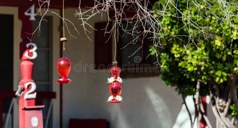 BOULDER, USA - FEBRUARY 2, 2018: Hummingbird glass drinkers. With selective focus. BOULDER, USA - FEBRUARY 2, 2018: Hummingbird glass drinkers. With selective focus.