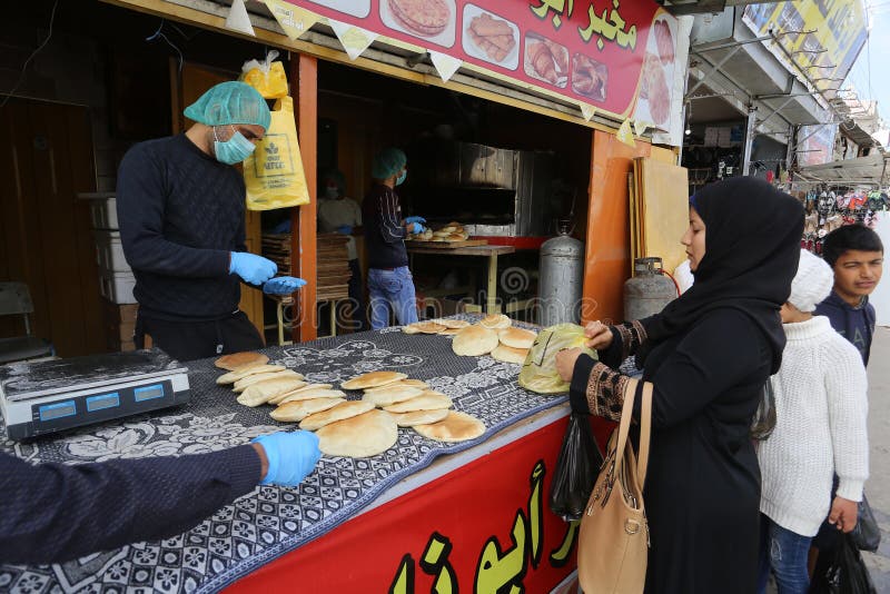 Palestinian workers wearing masks amid coronavirus precautions, bake bread at a bakery, in Rafah in the southern Gaza Strip, on March 10, 2020. Photo by Abed Rahim Khatib. Palestinian workers wearing masks amid coronavirus precautions, bake bread at a bakery, in Rafah in the southern Gaza Strip, on March 10, 2020. Photo by Abed Rahim Khatib