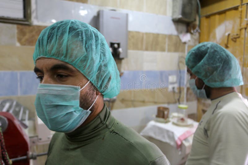 Palestinian workers wearing masks amid coronavirus precautions, bake bread at a bakery, in Rafah in the southern Gaza Strip, on March 10, 2020. Photo by Abed Rahim Khatib. Palestinian workers wearing masks amid coronavirus precautions, bake bread at a bakery, in Rafah in the southern Gaza Strip, on March 10, 2020. Photo by Abed Rahim Khatib