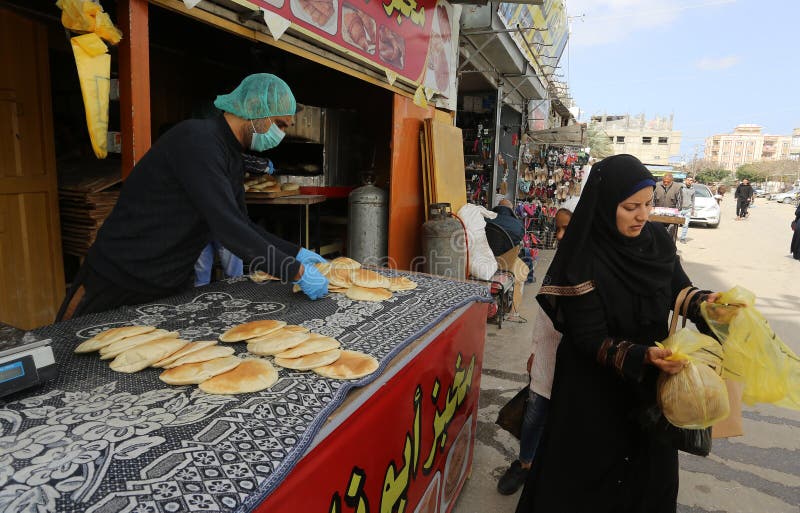 Palestinian workers wearing masks amid coronavirus precautions, bake bread at a bakery, in Rafah in the southern Gaza Strip, on March 10, 2020. Photo by Abed Rahim Khatib. Palestinian workers wearing masks amid coronavirus precautions, bake bread at a bakery, in Rafah in the southern Gaza Strip, on March 10, 2020. Photo by Abed Rahim Khatib