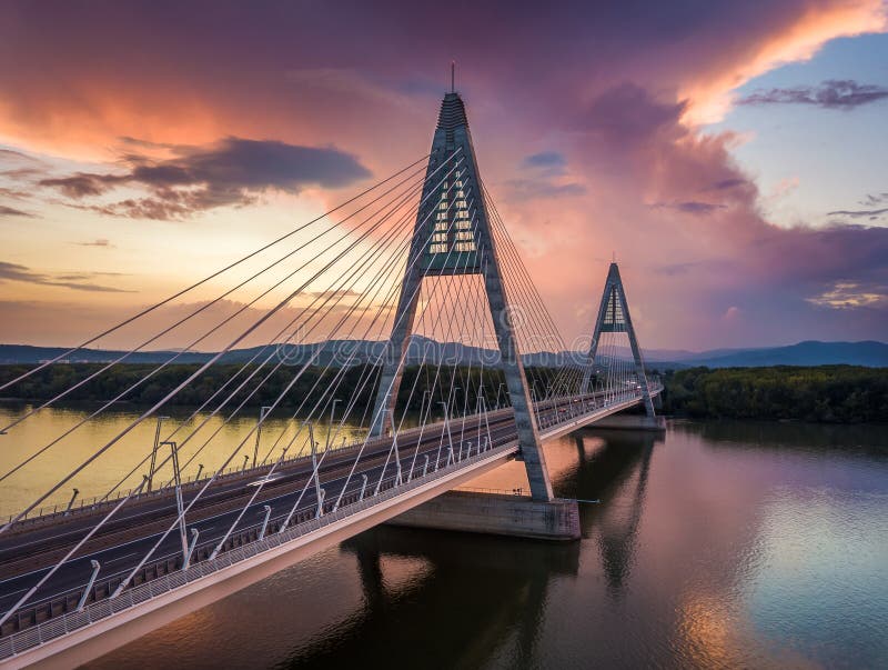 Budapest, Hungary - Megyeri Bridge over River Danube at sunset with beautiful dramatic clouds and sky. Budapest, Hungary - Megyeri Bridge over River Danube at sunset with beautiful dramatic clouds and sky