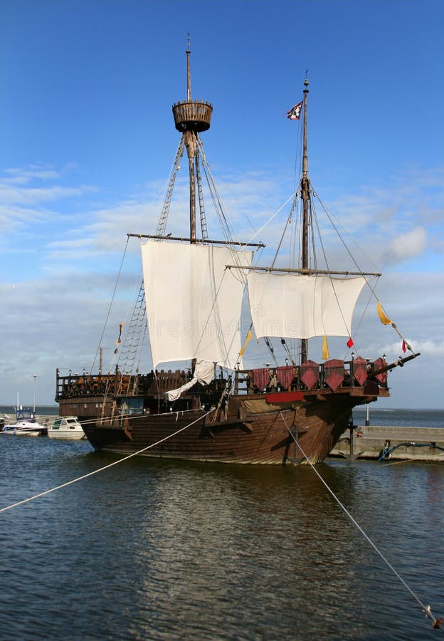 Old historic sailing ship with big sails in port of Curonian Spit in Lithuania. Old historic sailing ship with big sails in port of Curonian Spit in Lithuania.