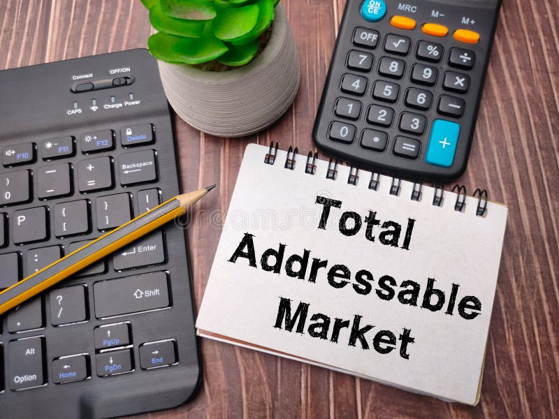 Notebook and pencil with the word Total Addressable Market. Business concept. Notebook and pencil with the word Total Addressable Market. Business concept.