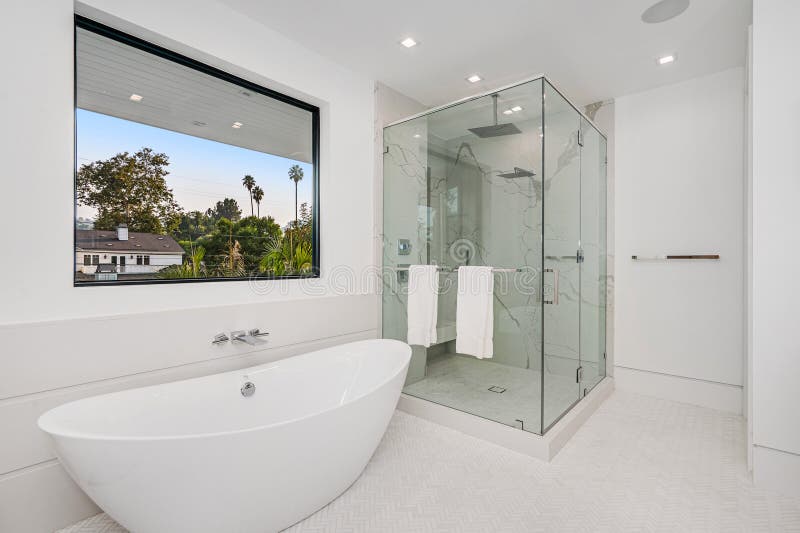 Modern bathroom with glass shower and central tub. Modern bathroom with glass shower and central tub