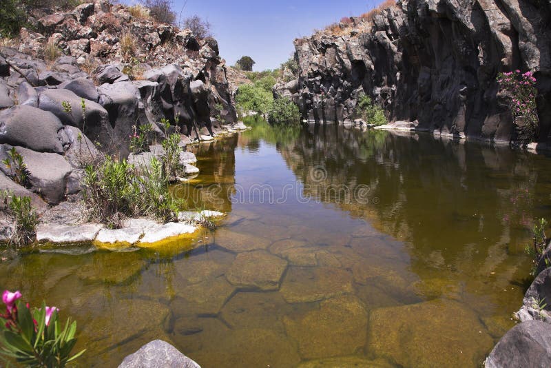 Drying up stream between picturesque stone polyhedrons in mountains of Israel. Drying up stream between picturesque stone polyhedrons in mountains of Israel