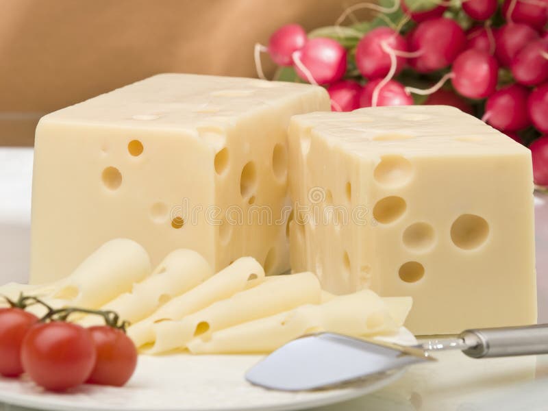 Slices of cheese with tomato and radishes. Slices of cheese with tomato and radishes