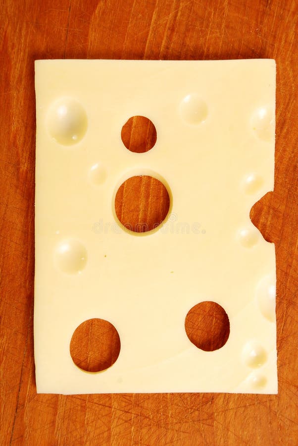 Sliced swiss cheese on wooden background. Sliced swiss cheese on wooden background