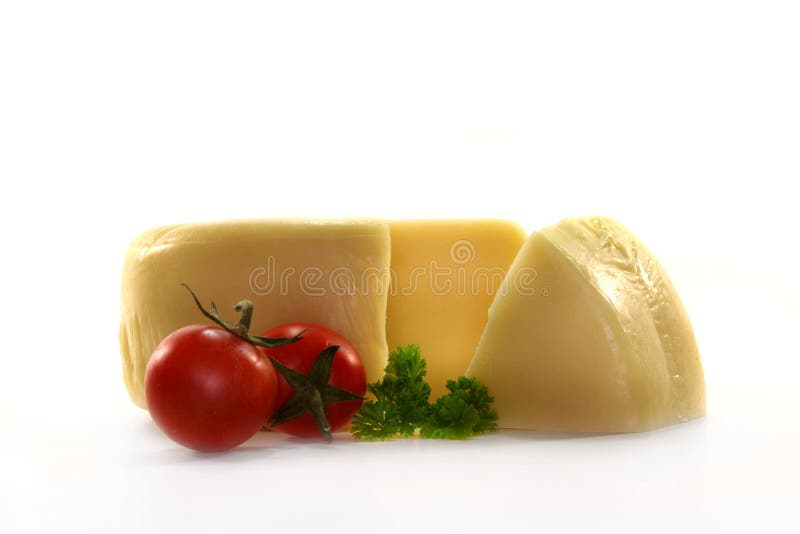 A loaf of cheese and fresh tomato on white background. A loaf of cheese and fresh tomato on white background