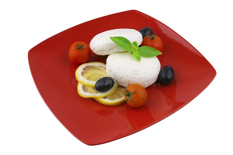 Light soft feta cheese on red dishware. Light soft feta cheese on red dishware