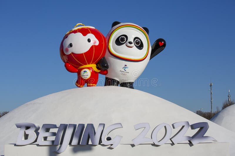 The statues of Bing Dwen Dwen and Shuey Rhon Rhon, people taking photos. Beijing Olympic Park, sunset. The statues of Bing Dwen Dwen and Shuey Rhon Rhon, people taking photos. Beijing Olympic Park, sunset