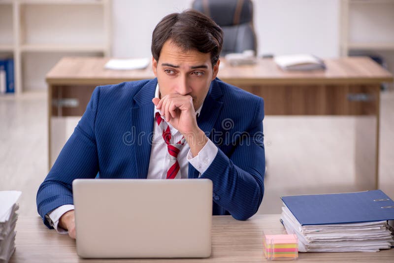 Young businessman employee and too much work in the office. Young businessman employee and too much work in the office