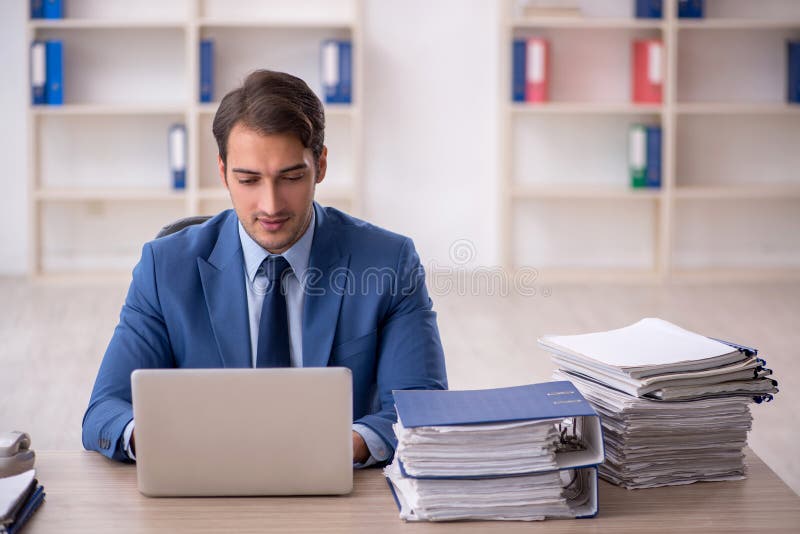 Young businessman employee and too much work in the office. Young businessman employee and too much work in the office