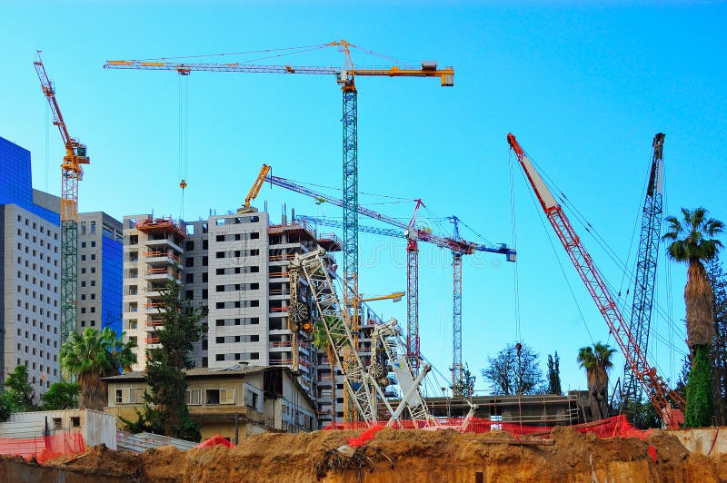 An urban construction site with many cranes. An urban construction site with many cranes