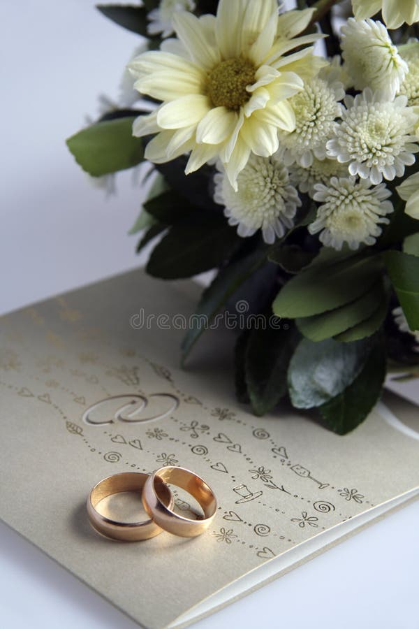 Picture of golden wedding rings, invitation and flowers. Picture of golden wedding rings, invitation and flowers