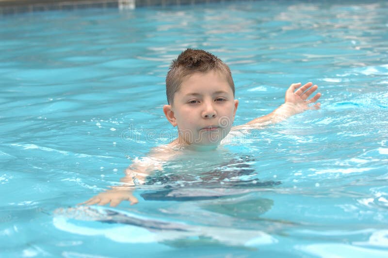 Boy swimming in pool, with his arms stretched out to each side. Boy swimming in pool, with his arms stretched out to each side.