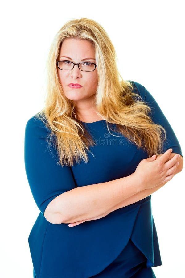 Savvy business woman stares intensely at camera while standing with her arms crossed. Savvy business woman stares intensely at camera while standing with her arms crossed