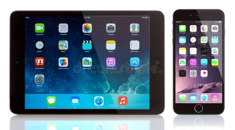 iPad Mini and iPhone 6 on white. Apple iOS 8 applications on the home screen of the iPhone 6 and iPad. iPad Mini and iPhone 6 on white. Apple iOS 8 applications on the home screen of the iPhone 6 and iPad.