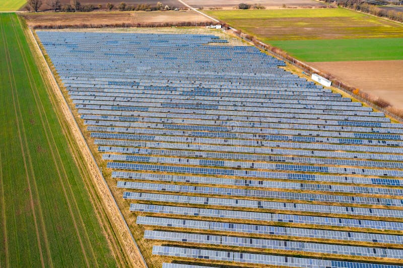 A ground-mounted solar plant between fields and meadows in Germany from a drone perspective. A ground-mounted solar plant between fields and meadows in Germany from a drone perspective