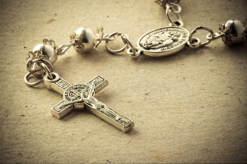 A rosary crucifix over a paper background. A rosary crucifix over a paper background.