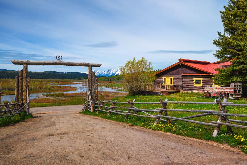 Moran, Wyoming, USA - June 8, 2022 : Buffalo Valley Ranch at the Buffalo Fork of the Snake River with the Grand Teton mountains in the background. Moran, Wyoming, USA - June 8, 2022 : Buffalo Valley Ranch at the Buffalo Fork of the Snake River with the Grand Teton mountains in the background.