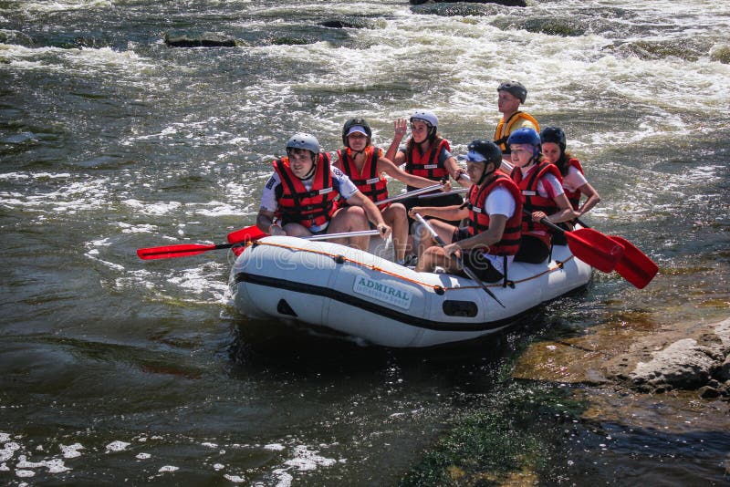 Sun Kosi near Harkapur / Nepal - August 30, 2018: Whitewater Rafting on the Dudh Koshi in Nepal. The river has class 4-5 rapids. Group of people whitewater rafting and rowing on river. Sun Kosi near Harkapur / Nepal - August 30, 2018: Whitewater Rafting on the Dudh Koshi in Nepal. The river has class 4-5 rapids. Group of people whitewater rafting and rowing on river