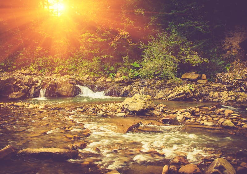 Beautiful landscape of rapids on a mountains river in sunrise. Filtered image: vintage effect. Beautiful landscape of rapids on a mountains river in sunrise. Filtered image: vintage effect.