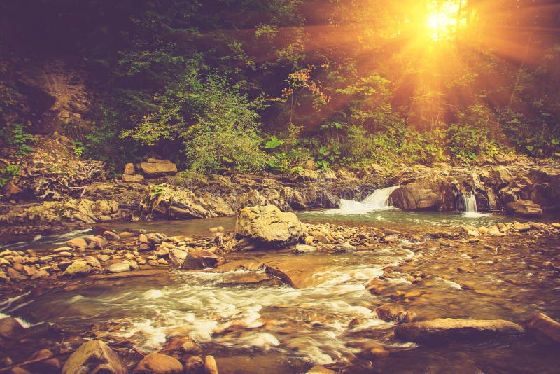 Beautiful landscape of rapids on a mountains river in sunrise. Filtered image: vintage effect. Beautiful landscape of rapids on a mountains river in sunrise. Filtered image: vintage effect.