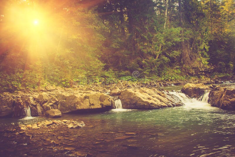 Beautiful landscape of rapids on a mountains river in sunrise. Filtered image: vintage effect. Beautiful landscape of rapids on a mountains river in sunrise. Filtered image: vintage effect.