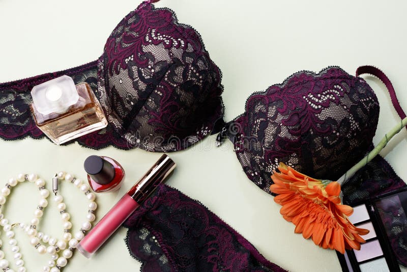 Sexy burgundy underwear, bra and panties. Cosmetics for girls, lipstick, perfumes, pearl necklaces. Sexy burgundy underwear, bra and panties. Cosmetics for girls, lipstick, perfumes, pearl necklaces