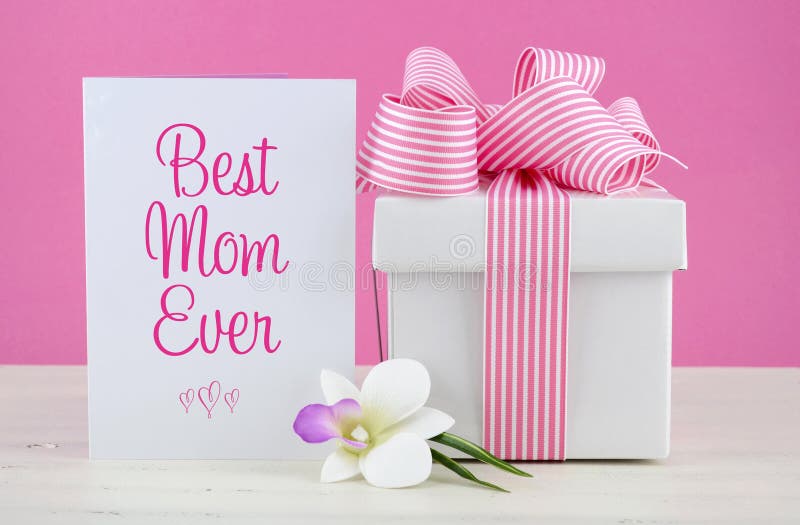 Happy Mothers Day pink and white gift with Best Mom Ever greeting card, on white shabby chic distressed wood table. Happy Mothers Day pink and white gift with Best Mom Ever greeting card, on white shabby chic distressed wood table.