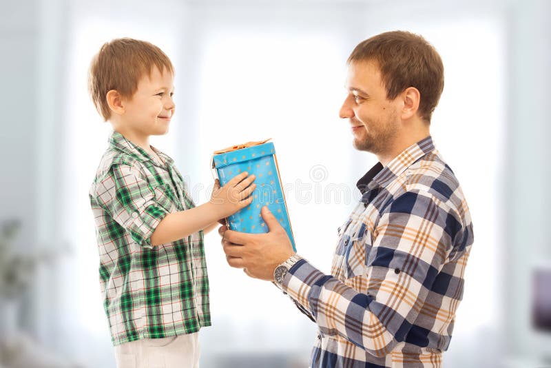 Happy son gives his father gift. Fathers day, family holiday, vacation. Happy son gives his father gift. Fathers day, family holiday, vacation.