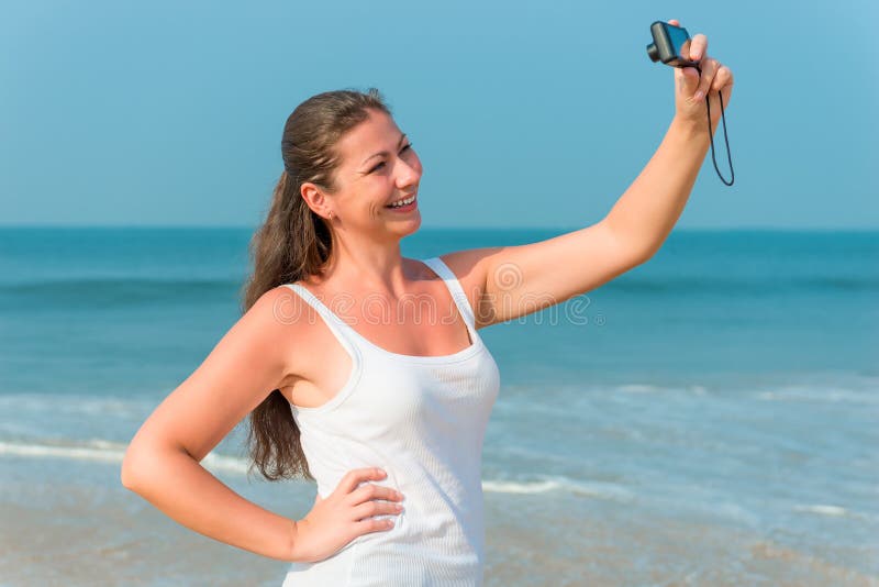 Happy brunette photographed yourself on the beach in the afternoon. Happy brunette photographed yourself on the beach in the afternoon