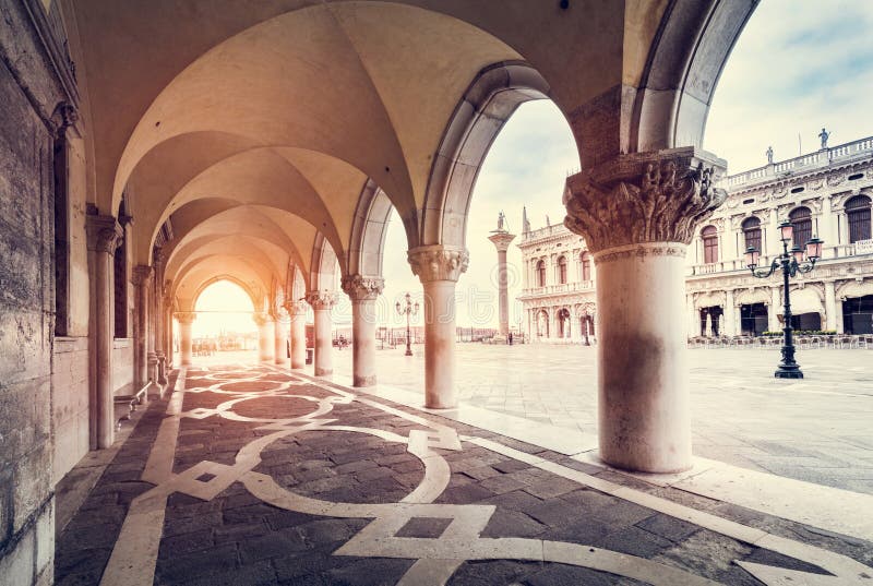 Ancient columns with arches at Palazzo Ducale or Doge&#x27;s Palace in Venice, Italy at sunrise. Ancient columns with arches at Palazzo Ducale or Doge&#x27;s Palace in Venice, Italy at sunrise