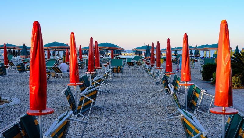 Fano beach, Marche, Italy. Colorful umbrellas. half open and half closed. this is end summer. Fano beach, Marche, Italy. Colorful umbrellas. half open and half closed. this is end summer..