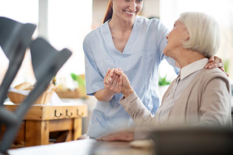 Thanking caregiver. Grey-haired aged women thanking caregiver for help and support. Thanking caregiver. Grey-haired aged women thanking caregiver for help and support