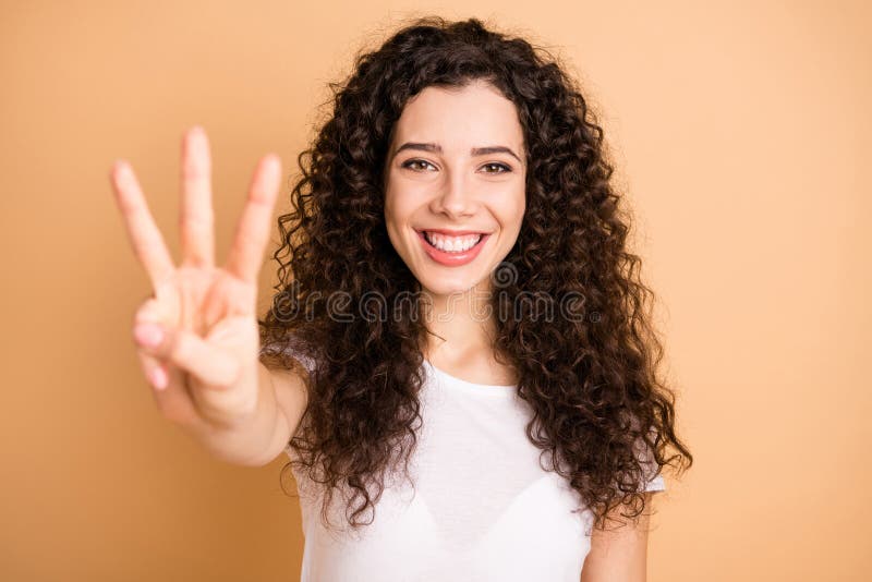 I`m counting to three. Closeup photo of funny lady raising hand showing, three fingers positive mood wear white casual outfit  beige pastel color background. I`m counting to three. Closeup photo of funny lady raising hand showing, three fingers positive mood wear white casual outfit  beige pastel color background