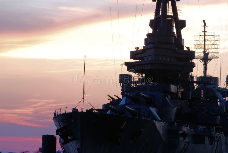 The historic monument USS Texas Battleship against a sunset sky. The historic monument USS Texas Battleship against a sunset sky.